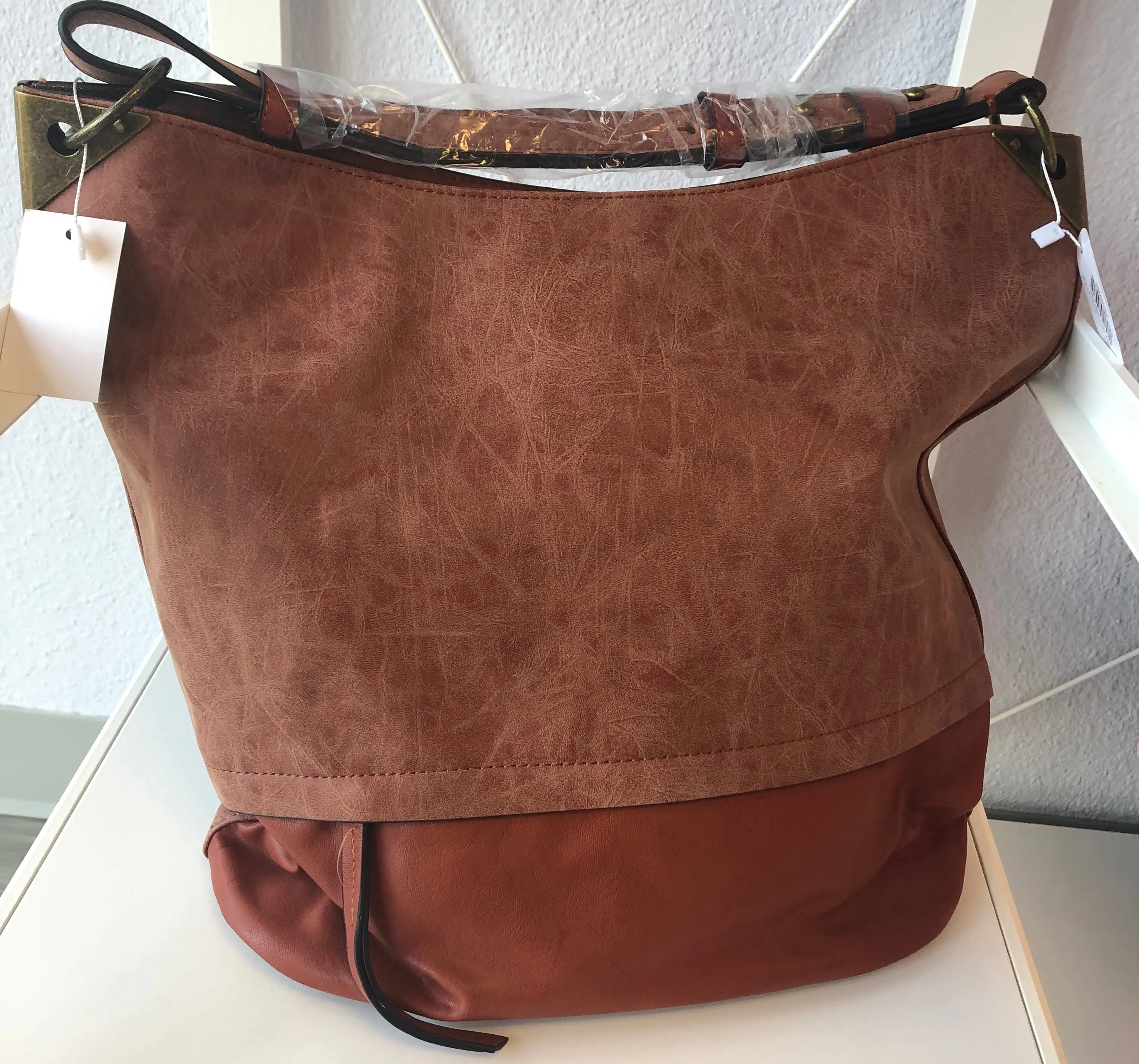 BUCKET HANDBAG WITH DISTRESSED TRIM